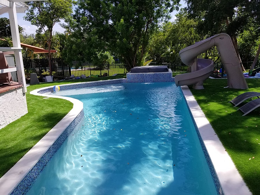 A backyard pool with a waterslide